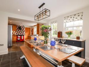 a kitchen with a long table with wine glasses at Park View in Bodmin
