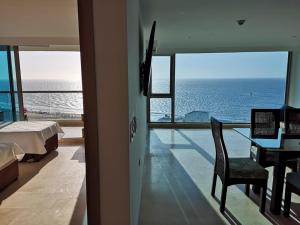 a bedroom with a bed and a view of the ocean at Luxury apartment in Morros - Cartagena de Indias in Cartagena de Indias