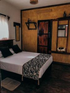 a bedroom with a large bed in a room at Chaak in Puerto Escondido