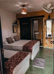 a hotel room with two beds and a window at Chaak in Puerto Escondido