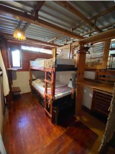 a room with two bunk beds in a boat at Chaak in Puerto Escondido