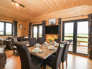 a dining room with a table and chairs at The Lodge at Crossroads Farm in Bridgwater