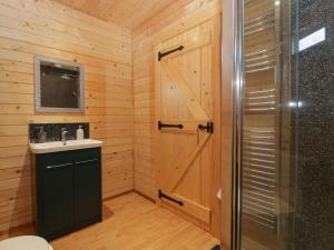 baño con ducha, lavabo y puerta en The Lodge at Crossroads Farm, en Bridgwater