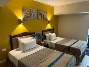 Letto o letti in una camera di Gawharet Al Ahram Hotel