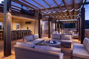 a patio with couches and a bar in the background at The Piccolo in Paso Robles