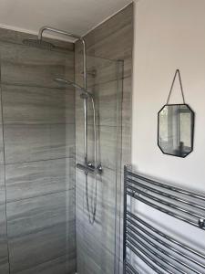a shower stall with a glass door in a bathroom at Single Room, Shared House in Bristol
