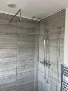 a shower with a glass door in a bathroom at Family room, Shared House in Bristol