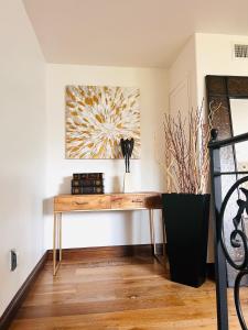 a desk in a room with a painting on the wall at The Cozy Villa in Los Angeles