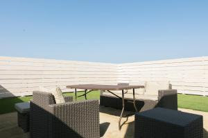 a patio with a table and chairs on a patio at 淡路島貸別荘リアンみなと in Minamiawaji