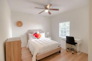 a bedroom with a bed and a desk and a ceiling fan at Retreat to a Stylish WOW Hotel Quality Two Story Upscale 4-2 in Historic Coconut Grove in Miami