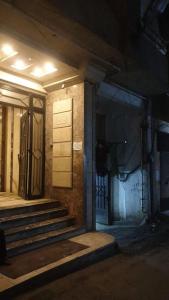 a building with stairs and a door at night at Newly renovated cozy studio 2 min 2 SEA in Alexandria