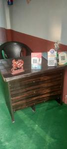 a wooden desk with signs on top of it at SPOT ON Gagan Hotel in Khatauli