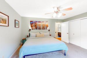 a bedroom with a bed and a ceiling fan at Valley Retreat - Upper in Holiday Island