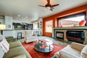 a living room with a couch and a fireplace at Arizona Vacation Rental with Private Pool and Pergola! in Phoenix