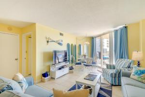 uma sala de estar com um sofá e uma televisão em North Carolina Escape with Balcony and Pool Access! em North Topsail Beach