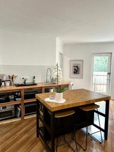 a kitchen with a large wooden island in the middle at Guest house on the park in Burwood East