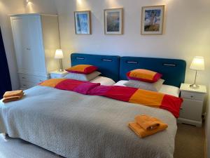 a bedroom with a large bed with colorful sheets and pillows at Apartman Brno Stred in Brno