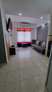 a large living room with a couch and a window at Huilliches NQN in Neuquén