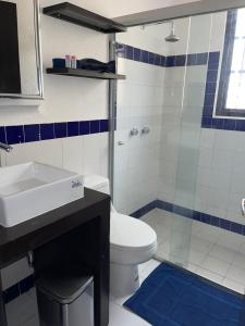 a bathroom with a toilet and a sink and a shower at Deco 3 Downtown 3 bed Apartment in Cancún