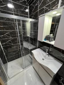 a bathroom with a shower and a sink and a mirror at NEAR SUITES in Istanbul