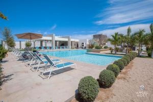 a swimming pool with lounge chairs and a resort at Hispania - Dreamy Family Homes plus Communal Pool and Playground in La Paz