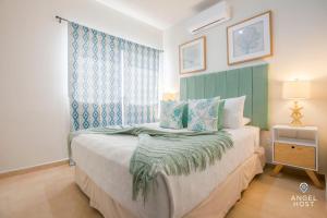 a bedroom with a bed with blue and green curtains at Hispania - Dreamy Family Homes plus Communal Pool and Playground in La Paz