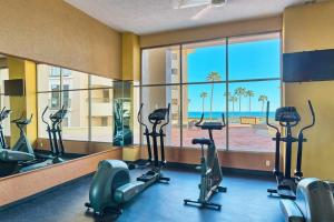 a gym with cardio machines and a view of the ocean at Sandy Beach Sonoran Spa W504 Ocean Front Resort in Puerto Peñasco