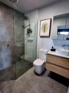 a bathroom with a toilet and a shower and a sink at Melazzano in Lilydale