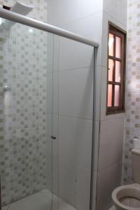 a glass shower in a bathroom with a toilet at Espaço A Corrente in Embu