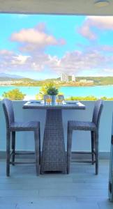 a table and chairs on a balcony with a view at Ocean Zen in Fajardo