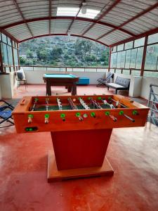 a ping pong table in the middle of a room at Brianny Hotel in Churín