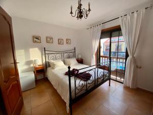 a bedroom with a black bed and a balcony at Bedroom Medanomar 2 in El Médano