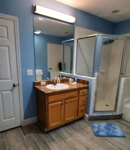 a bathroom with a sink and a shower at Caribe Cove in Kissimmee