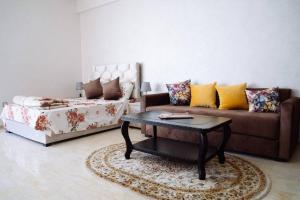 a living room with a couch and a coffee table at Cozy New Studio in Mohammedia in Mohammedia