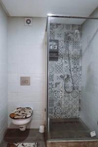 a bathroom with a shower and a toilet at Cozy New Studio in Mohammedia in Mohammedia