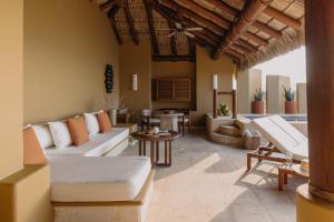 a living room with a couch and a table at Cala de Mar Resort & Spa Ixtapa in Ixtapa