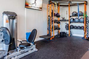 a room with a gym with weights and equipment at Chic Apt with Jacuzzi, Pool Nr Casino & Shopping in Sparks