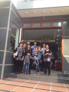 a group of people standing outside of a building at Family Airport Hotel - 5 minutes Noi Bai in Noi Bai