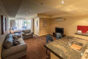 a large living room with a couch and a tv at Apartment 1, 9 River Lane, Mannum in Mannum