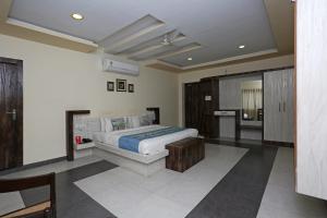a bedroom with a bed in a room with at Hotel Greenland in Udaipur