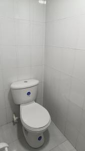 a bathroom with a white toilet in a room at Edificio El Trébol in Bogotá