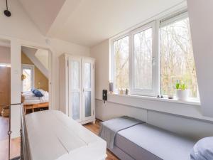 a white room with a bench and windows at Atmospheric holiday home in Noordwijkerhout near the beach in Noordwijkerhout