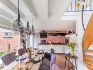 a dining room and kitchen with a table and chairs at Atmospheric holiday home in Noordwijkerhout near the beach in Noordwijkerhout