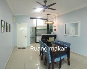 a dining room with a table and a ceiling fan at D' Palm Garden Homestay Lahad Datu. in Lahad Datu