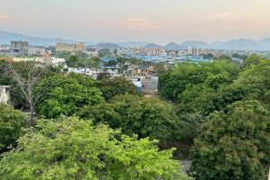 a view of a city with trees and buildings at TrueLife Homestays - SRS Residency - 2BHK AC apartments for families visiting Tirupati Temple - Fast WiFi, Kitchen, Android TV - Walk to PS4 Pure Veg Restaurant, Mayabazar Super Market - Easy access to Airport, Railway Station, All Temples in Tirupati