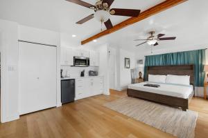 a bedroom with a bed and a ceiling fan at Ocean View Balcony Large Studio w extra Sofa Bed, contact us for price drop in Haleiwa