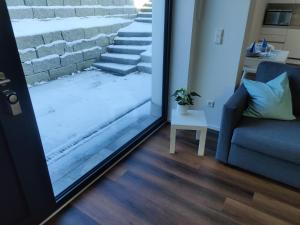 a room with a sliding glass door with a couch and stairs at Ferienwohnung Eyach in Balingen
