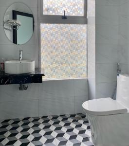 a bathroom with a sink and a toilet and a mirror at Hanoi Hidden Guest House in Hanoi +20 photos