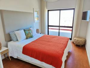a bedroom with a large bed with a large window at Hostel Aveiro in Aveiro