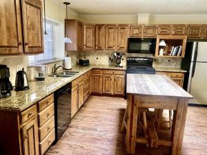 a kitchen with wooden cabinets and a wooden counter top at I40 Large Tuscany 4 bed 20min PDC in Amarillo